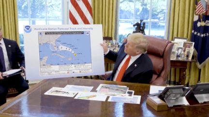 Donald Trump in the Oval Office with Hurricane Dorian projection map