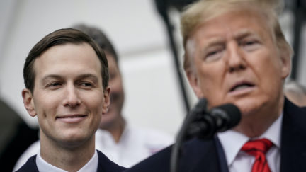Jared Kushner stands next to President Donald Trump at the microphone