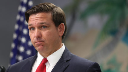 Ron DeSantis standing in front of an American flag