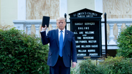 President Donald Trump holds a Bible while visiting St. John's Church across from the White House