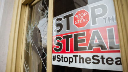 'Stop the Steal' sign posted in broken window in U.S. Capitol