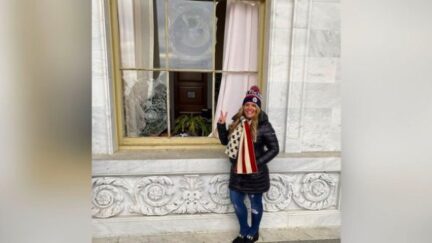 Jenna Ryan Posing Next to Broken Window at US Capitol