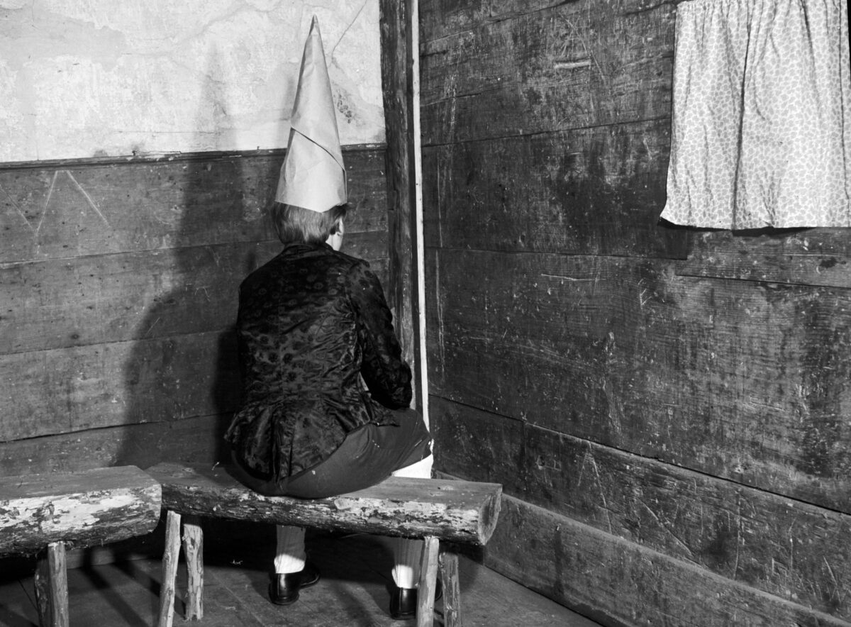 child wearing dunce cap