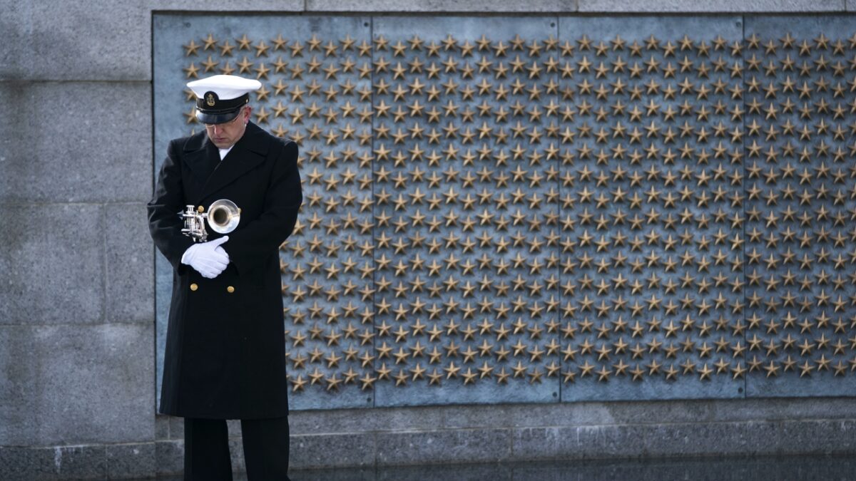 WASHINGTON, DC - DECEMBER 07: A trumpeter with a military honor guard pauses at the World War II Memorial during a wreath-laying ceremony to mark National Pearl Harbor Remembrance Day on December 7, 2020 in Washington, DC. On Dec. 7th, 1941, more than 2,400 Americans lost their lives in the surprise attack on a U.S. Naval station at Pearl Harbor by the Imperial Japanese Navy Air Service. The attack was the catalyst for the United States' entry into World War II. (Photo by Drew Angerer/Getty Images)