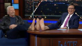 Richard Branson and Colbert play footsie