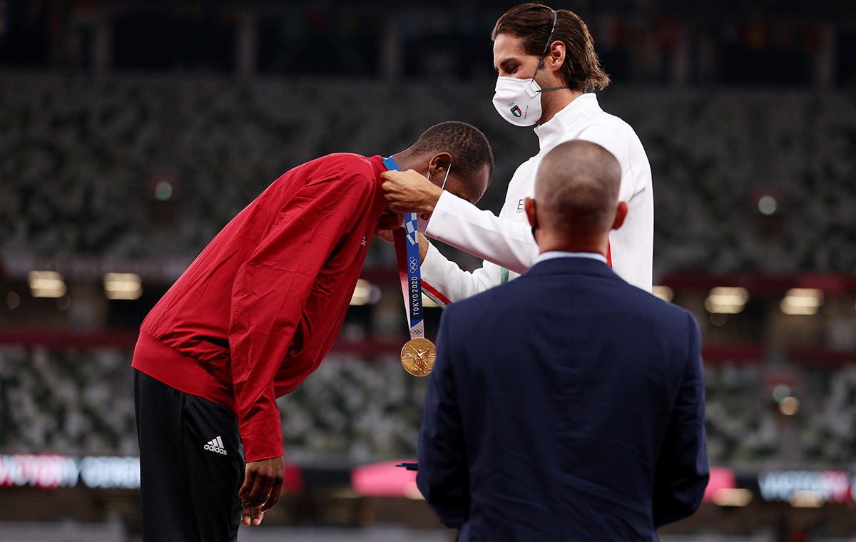 oint gold medalist Gianmarco Tamberi of Team Italy presents gold medalist Mutaz Essa Barshim of Team Qatar with his medal on the podium during the medal ceremony for the Mens High Jump on day ten of the Tokyo 2020 Olympic Games at Olympic Stadium on August 02 2021 in Tokyo Japan