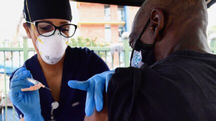Vocational nurse Christina Garibay (L) administers Johnson & Johnson's Janssen Covid-19 vaccine to a man at a Skid Row community outreach event where Covid-19 vaccines and testing were offered in Los Angeles, California on August 22, 2021.