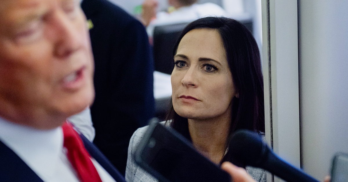 White House Press Secretary Stephanie Grisham listens to U.S. President Donald Trump speak to the media aboard Air Force One during a flight from El Paso, Texas to Joint Base Andrews, Md., On August 7, 2019.