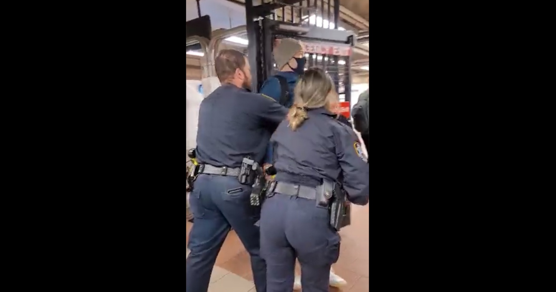 Police shoving man out of the subway