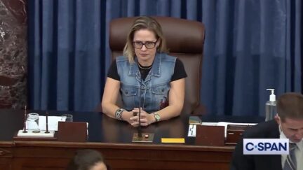 Kyrsten Sinema wearing a demin vest in the Senate chamber