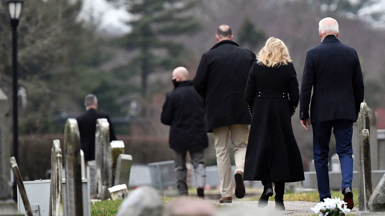 US President Joe Biden (R) and First Lady Jill Biden (2nd R) walk towards the graves of President Biden's first wife and children after visiting St. Joseph on the Brandywine Catholic Church in Wilmington, Delaware, on December 18, 2021. (Photo by MANDEL NGAN / AFP) (Photo by MANDEL NGAN/AFP via Getty Images)