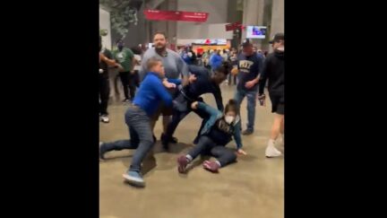Woman gets knocked down during Peach Bowl brawl