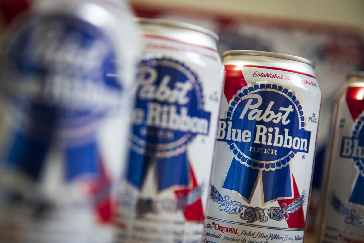 Cans of Pabst Blue Ribbon beer sit on a table