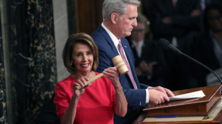nancy pelosi smiling with gavel and kevin McCarthy in the background january 2019
