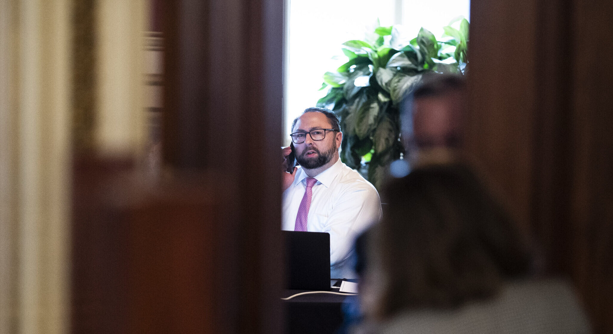 ason Miller works in a meeting room for lawyers of former President Donald Trump on the fourth day of the Senate Impeachment trials for former President Donald Trump.