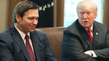 ron DeSantis at table with donald trump