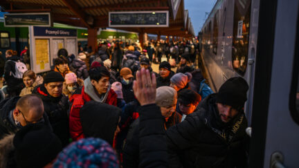People who fled the war in Ukraine line up to board a train towards Warsaw after arriving at the main train station from the Polish Ukrainian border on March 04, 2022 in Przemysl, Poland.