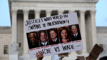 A pro-choice activist holds up a sign during a rally in front of the U.S. Supreme Court in response to the leaked Supreme Court draft decision to overturn Roe v. Wade May 3, 2022 in Washington, DC.