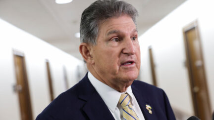 Joe Manchin speaking to reporters in senate office hallway