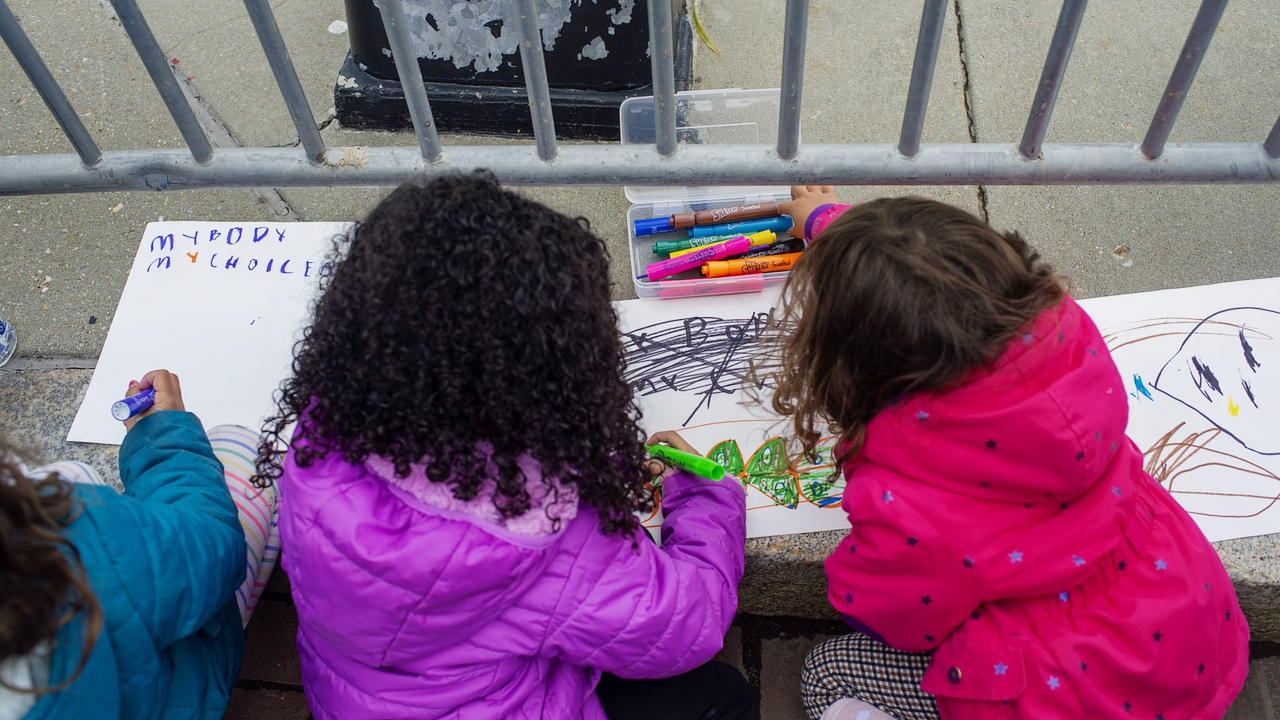 WASHINGTON, DC - MAY 08: A group of girls make posters during an abortion-rights Mothers Day demonstration outside the U.S. Supreme Court on May 8, 2022 in Washington, DC. The building, currently surrounded by a temporary fence, has been the site of abortion-rights and anti-abortion activist demonstrations since the leaked draft of the Court's potential decision to overturn Roe v. Wade nearly one week ago. (Photo by Bonnie Cash/Getty Images)