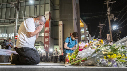 Former Japanese Prime Minister Shinzo Abe assassinated. Citizens pray at makeshift memorial.