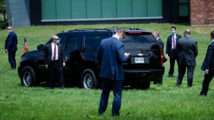 Members of the Secret Service guard the US president's limo as he leaves a Memorial Day event at the Fort McHenry National Monument May 25, 2020, in Baltimore, Maryland.