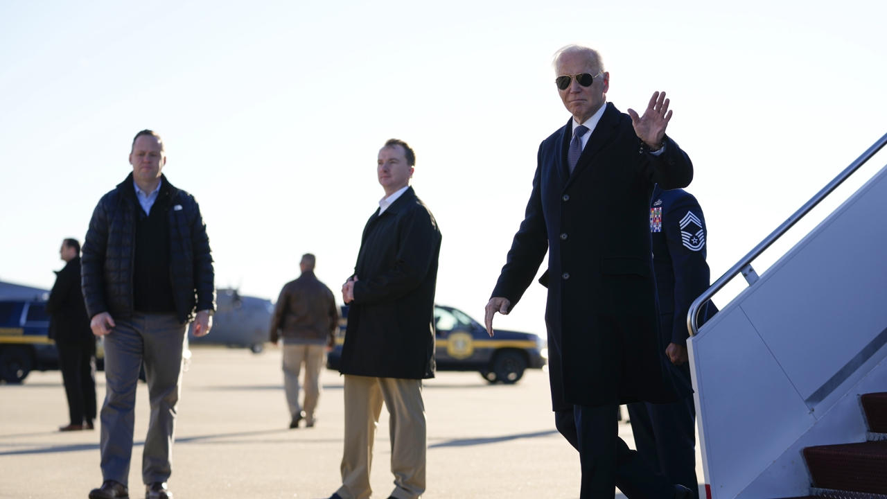 President Joe Biden waves as he arrives on Air Force One at Delaware Air National Guard Base in New Castle, Del., Sunday, Jan. 15, 2023. 