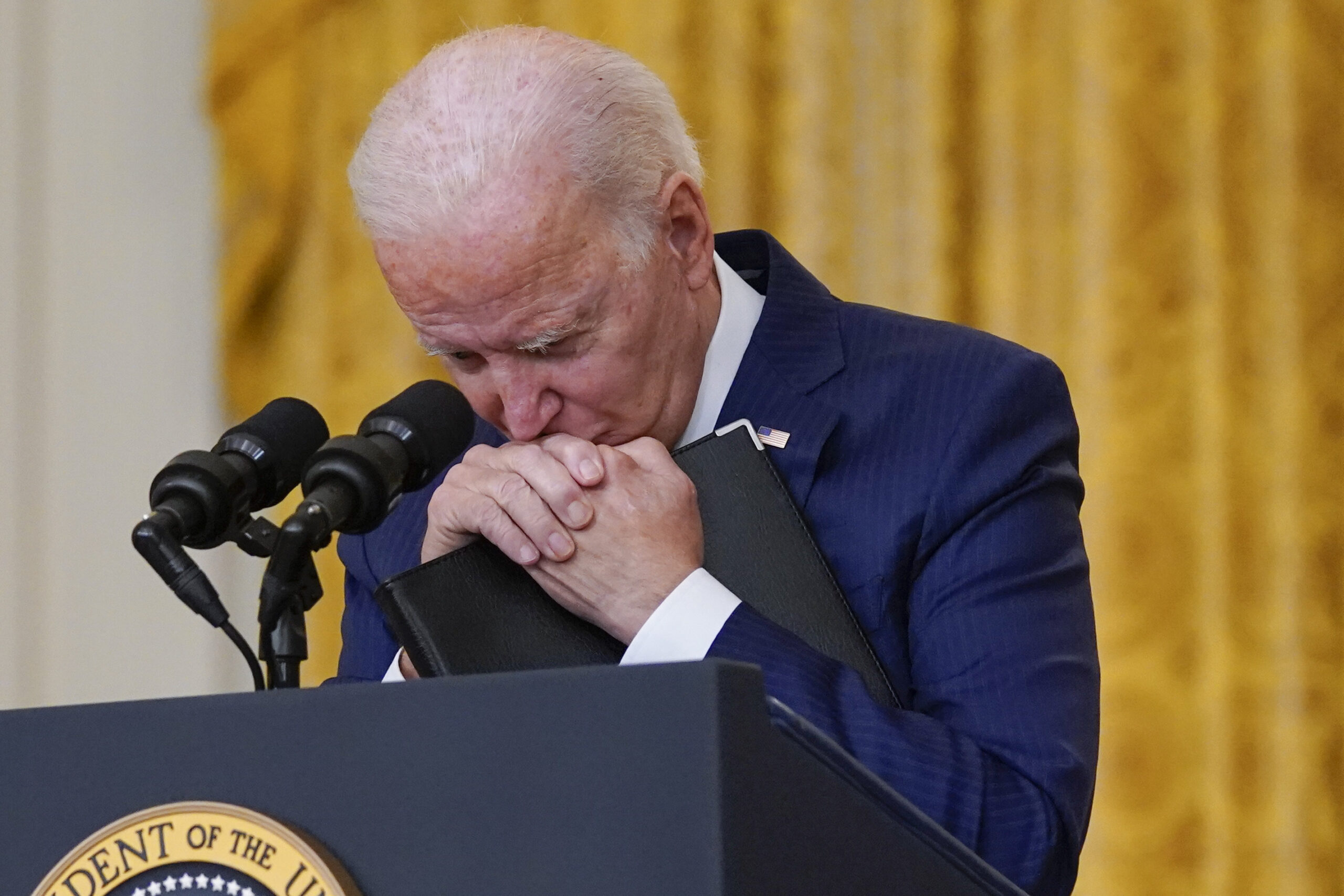 FILE - President Joe Biden pauses as he listens to a question about the bombings at the Kabul airport that killed at least 12 U.S. service members, from the East Room of the White House, Aug. 26, 2021, in Washington.