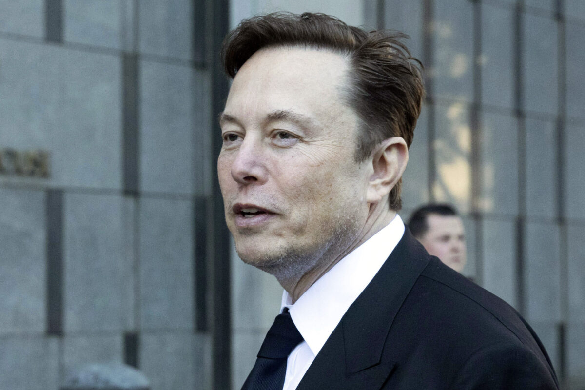 Elon Musk in a suit and tie