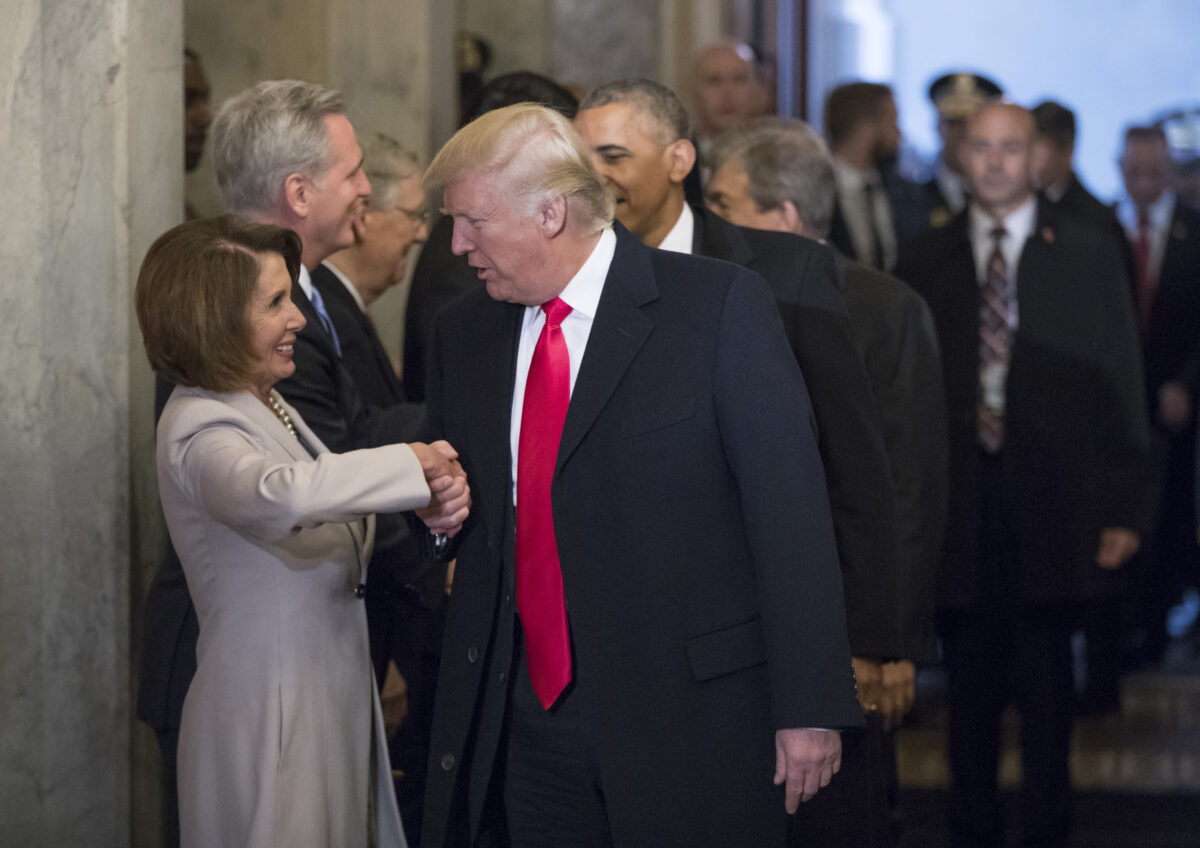 Nancy Pelosi shaking hands with Donald Trump