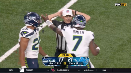 Seattle Seahawks quarterback Geno Smith argues a penalty with referee Alex Kemp