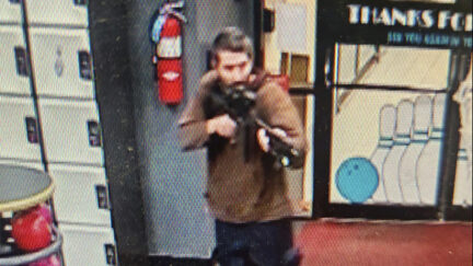 In this image taken from video released by the Androscoggin County Sheriff's Office, an unidentified gunman points a gun while entering Sparetime Recreation in Lewiston, Maine, on Wednesday, Oct. 25, 2023. Maine State Police ordered residents in the state's second-largest city to shelter in place Wednesday night as the suspect remains at large.