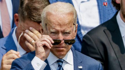 President Joe Biden puts on his sunglasses during a ceremony on the South Lawn of the White House, in Washington, Tuesday, July 20, 2021, where Biden will honor the Super Bowl Champion Tampa Bay Buccaneers for their Super Bowl LV victory.