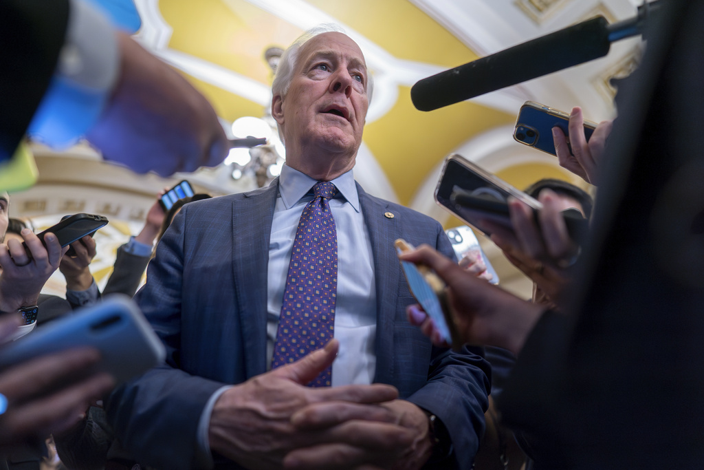 Sen. John Cornyn, R-Texas, is surrounded by reporters as he heads to the chamber during a test vote to begin debate on a border security bill, at the Capitol in Washington, Wednesday, Feb. 7, 2024.