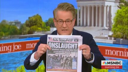 Joe Scarborough holding up New York Post with 