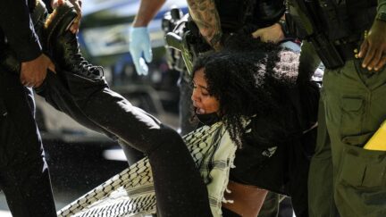 Authorities detain a protester on the campus of Emory University during a pro-Palestinian demonstration, Thursday, April 25, 2024, in Atlanta.