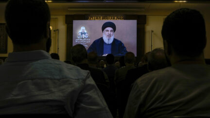 Hezbollah supporters watch a speech given by Hezbollah leader Sayyed Hassan Nasrallah on a screen during a ceremony to commemorate the death of senior Hezbollah commander Taleb Sami Abdullah, 55, who was killed last week by an Israeli strike in south Lebanon, in the southern Beirut suburb of Dahiyeh, Lebanon, Wednesday, June 19, 2024.