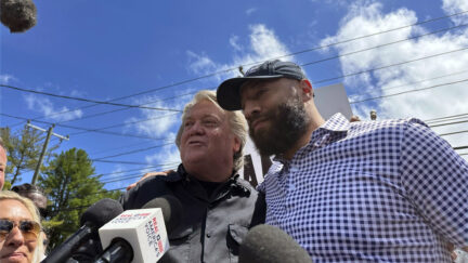 Republican Senate candidate Royce White, right, stands in solidarity with longtime Donald Trump ally Steve Bannon, as Bannon reports to the federal prison in Danbury, Conn., July 1, 2024. Bannon's backing helped White secure the Minnesota GOP endorsement to challenge Democratic incumbent Sen. Amy Klobuchar.