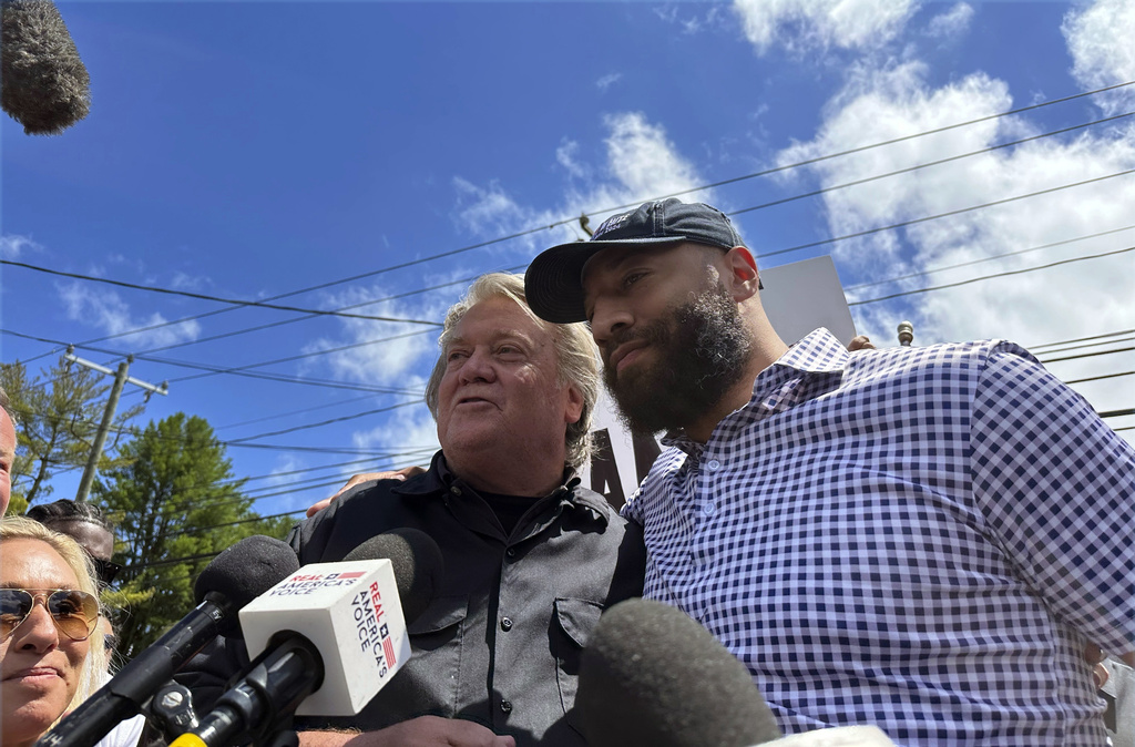 Republican Senate candidate Royce White, right, stands in solidarity with longtime Donald Trump ally Steve Bannon, as Bannon reports to the federal prison in Danbury, Conn., July 1, 2024. Bannon's backing helped White secure the Minnesota GOP endorsement to challenge Democratic incumbent Sen. Amy Klobuchar.