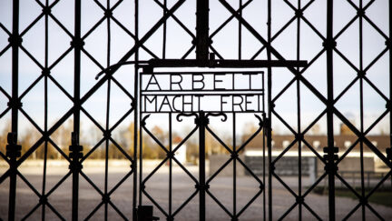 Entrance gate at Dachau concentration camp in Germany showing 
