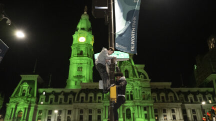 Philadelphia Eagles fans climb street light