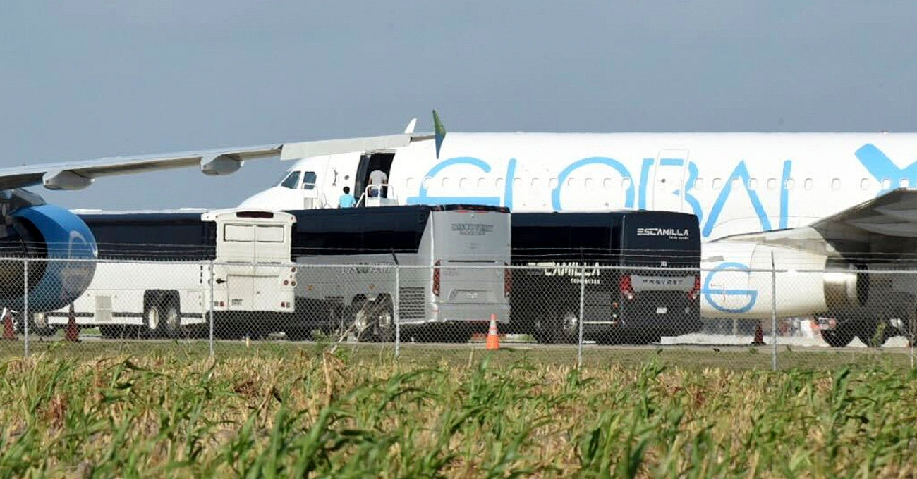 People board plane in Texas on Sunday, Aug. 31 where four charter buses unload as Trump tries to deport dozens of Guatemalan children. - AP
