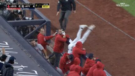 Yankees third baseman Ryan McMahon flips into Red Sox dugout