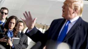 White House press secretary Stephanie Grisham listens as President Donald Trump, speaks to reporters on the South Lawn of the White House in Washington, Friday, Nov. 8, 2019, before boarding Marine One for a short trip to Andrews Air Force Base, Md. and then on to Georgia to meet with supporters.