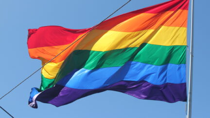 pride flag, rainbow flag with blue sky