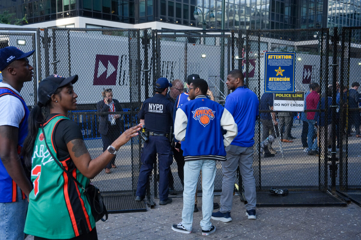 New York Knicks fans wait behind a security gate in front of Madison Square Garden ahead of Game 3 of the NBA Finals, Monday, June 8, 2026, in New York. (AP Photo/Ryan Murphy)
