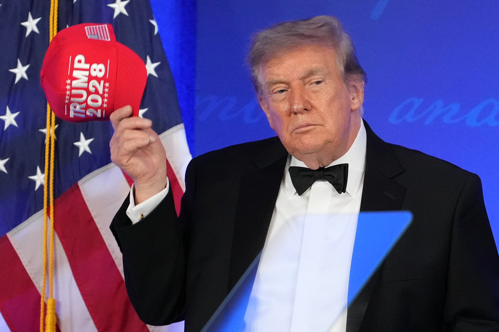 trump in a tux with red trump 2028 hat at whcd