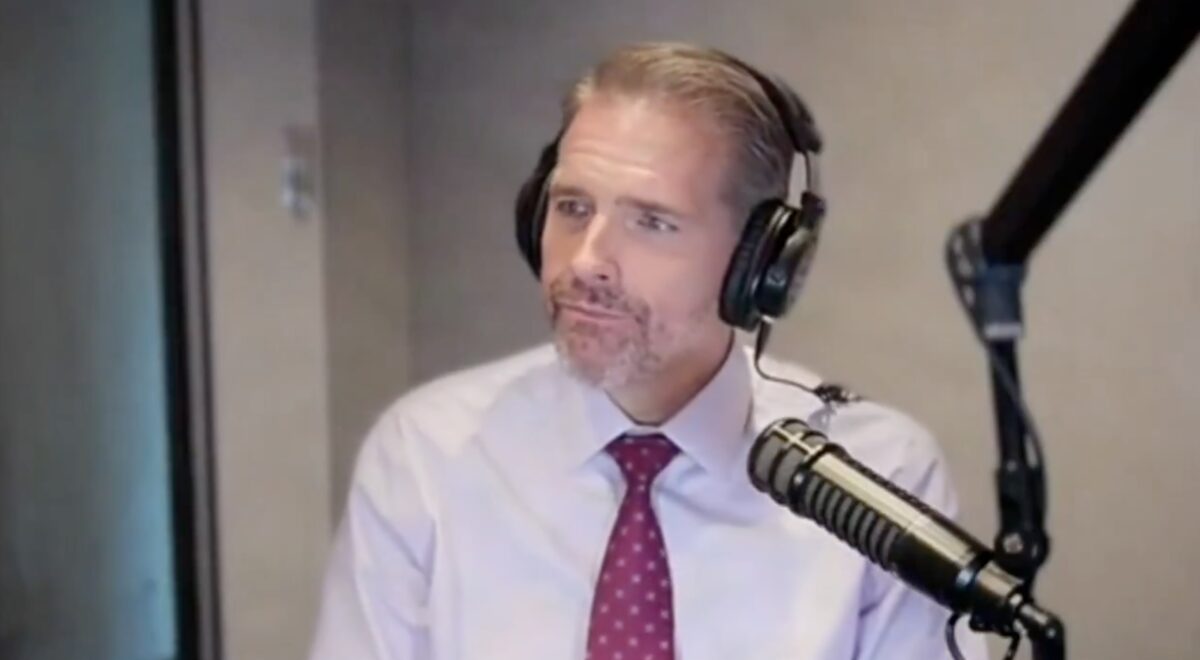 Scott Jennings on his radio show with a mic in front of him and headphones