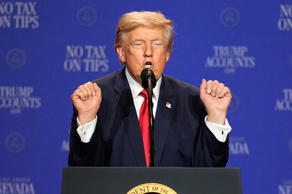 trump at a podium with his hands in fists raised to shoulder level
