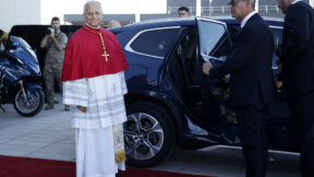 pope leo arrives in paris as a man in a black suit and sunglasses holds open a limo door for the pontiff
